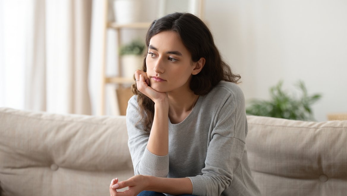 Девушка сидит одна в комнате